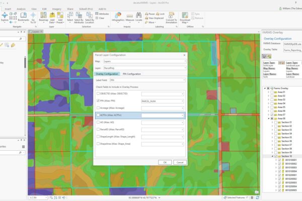 A GIS software interface displays a terrain map with the FARMS "Parcel Layer Configuration" settings window open in the center, allowing users to edit overlay parameters for farmland assessment and management.