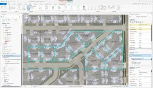 A GIS map interface displaying a residential area with Parcel Fabric boundaries outlined in turquoise and labeled with parcel identification numbers. Various toolbar options are visible at the top.